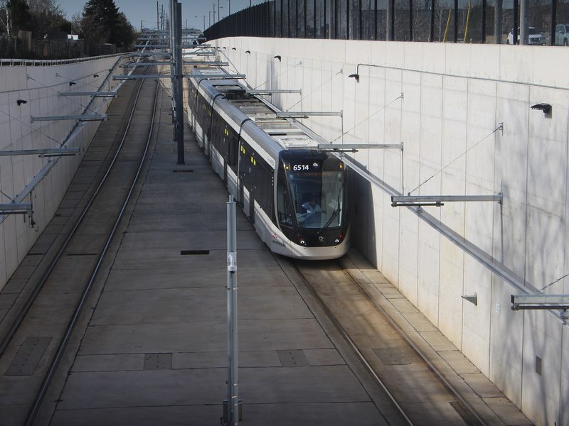 Finch West LRT vehicle in the trench approaching the tunnel. Photo by wltmauc, CC BY-SA 4.0