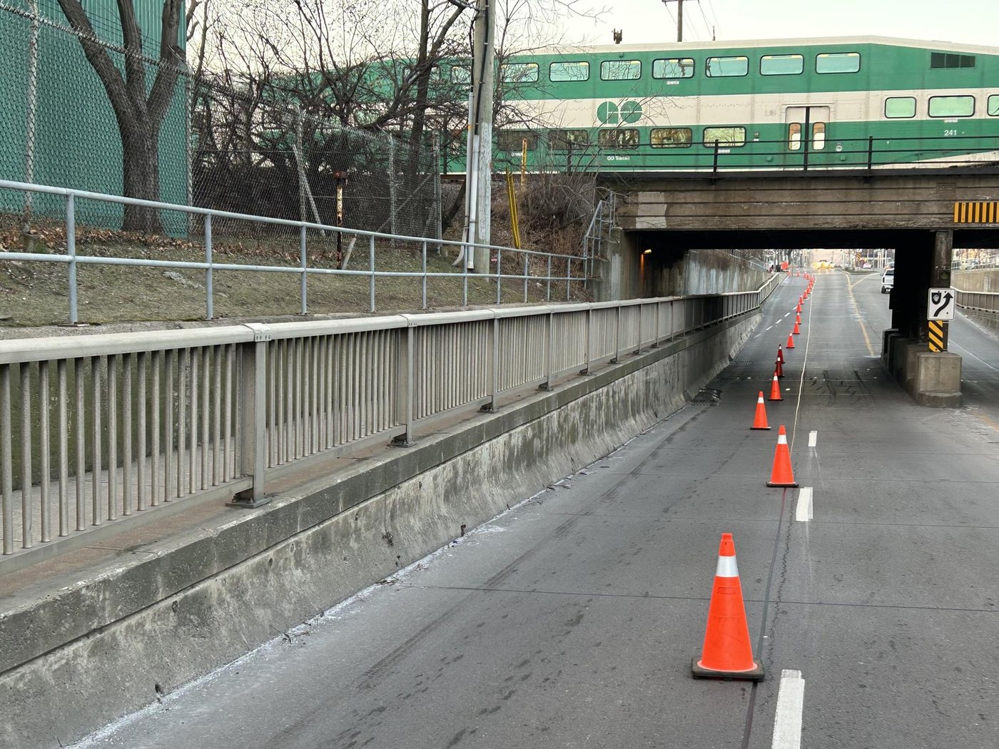 GO train crossing a rail overpass above retaining walls on a Hamilton road underpass. Photo by the ART Engineering inspection team